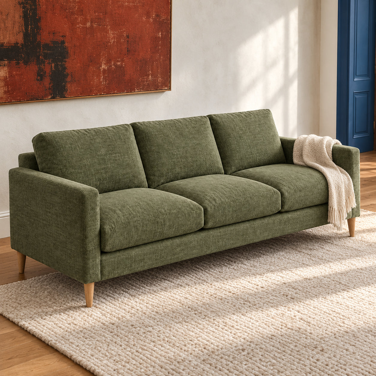 Olive three-seat sofa with rust-red artwork, illustrative room concept