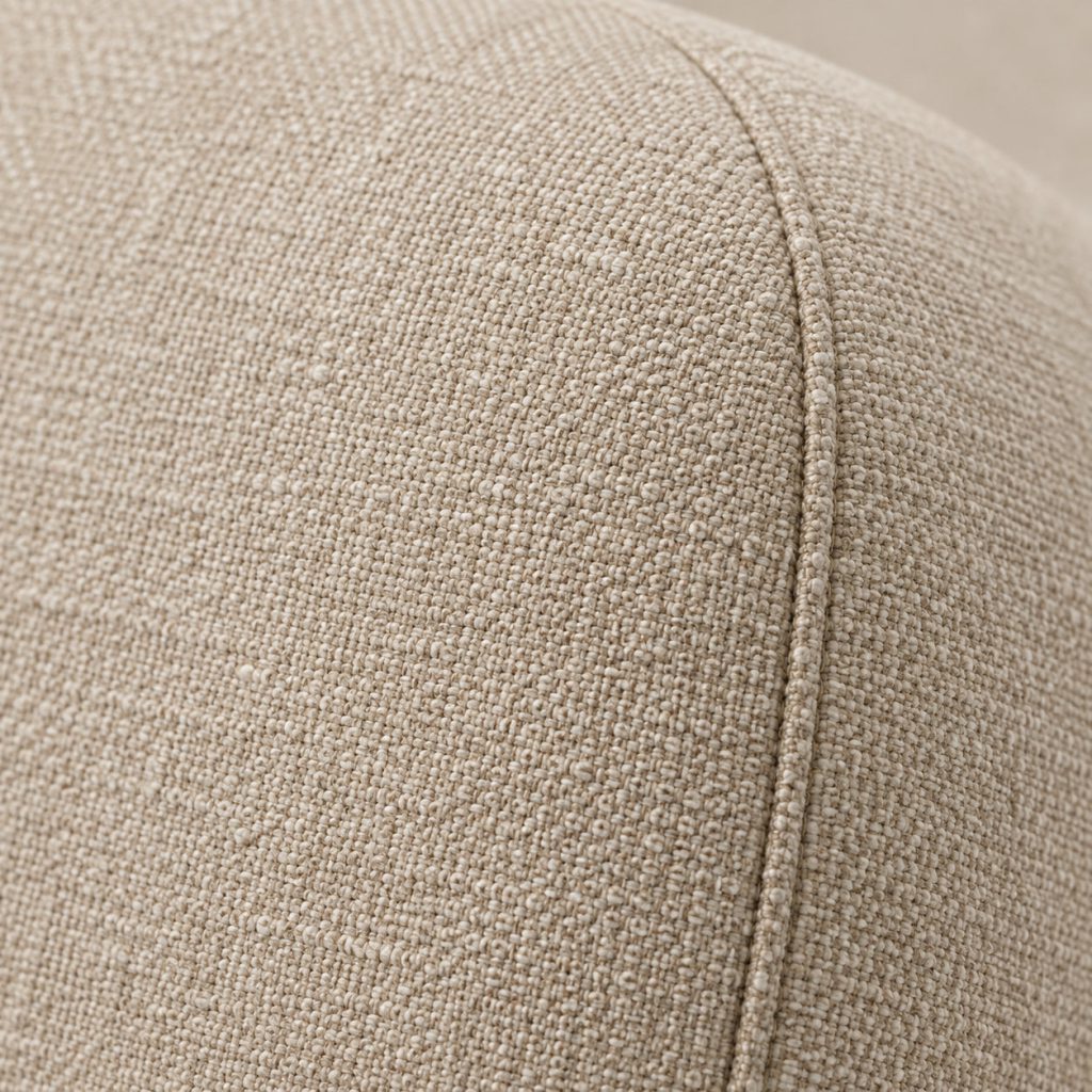 Close-up of oat woven upholstery with a seam